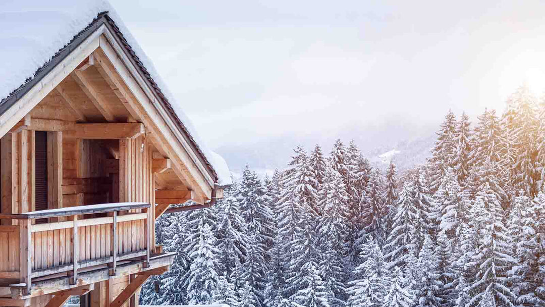 A wooden ski chalet among snow-covered pine trees