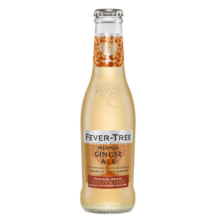A clear glass bottle of Fever Tree - Ginger Ale is filled with an amber liquid. The label showcases orange and gold accents, highlighting text that describes it as a Premium Ginger Ale made with a blend of three gingers.